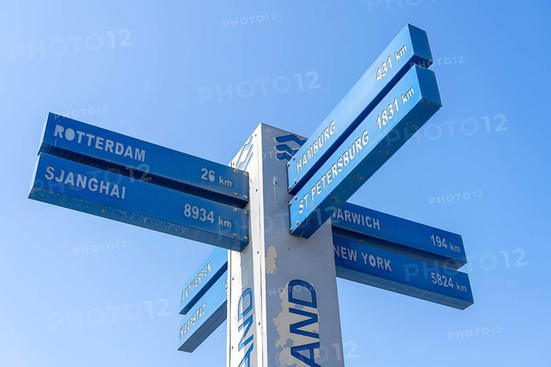 Signposts, cardinal points, to near and far destinations, on the beach of Hoek van Holland, low season, Netherlands