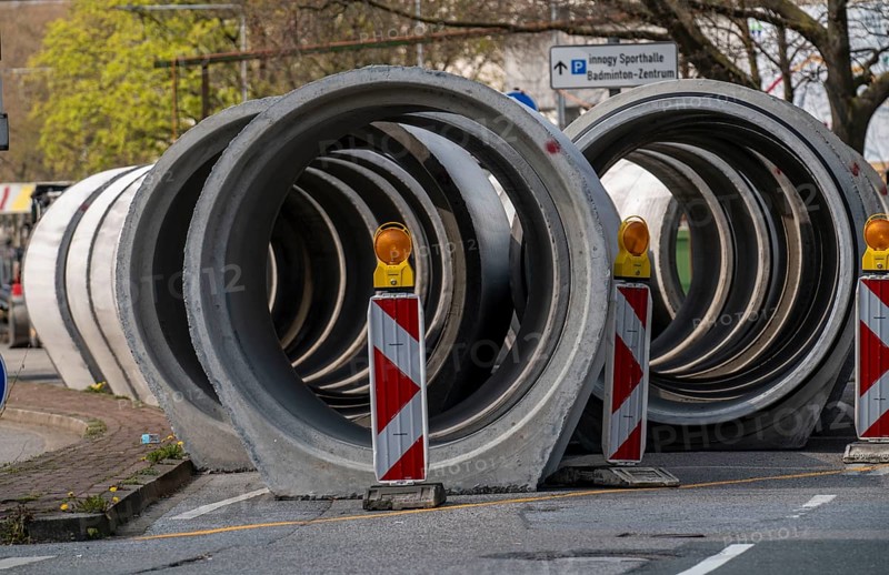 Concrete sewer pipes, stored on a construction site during sewer renovation work, on the Dickswall, city centre of Mülheim an der Ruhr, North Rhine-Westphalia, Germany, Europe