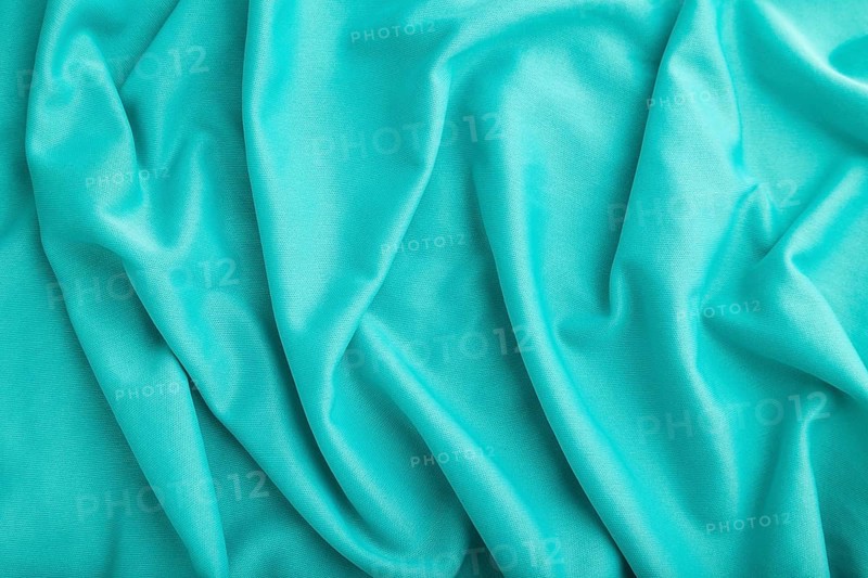 Fragment of silk blue tissue. Top view, natural textile background and texture. wave concept, abstract