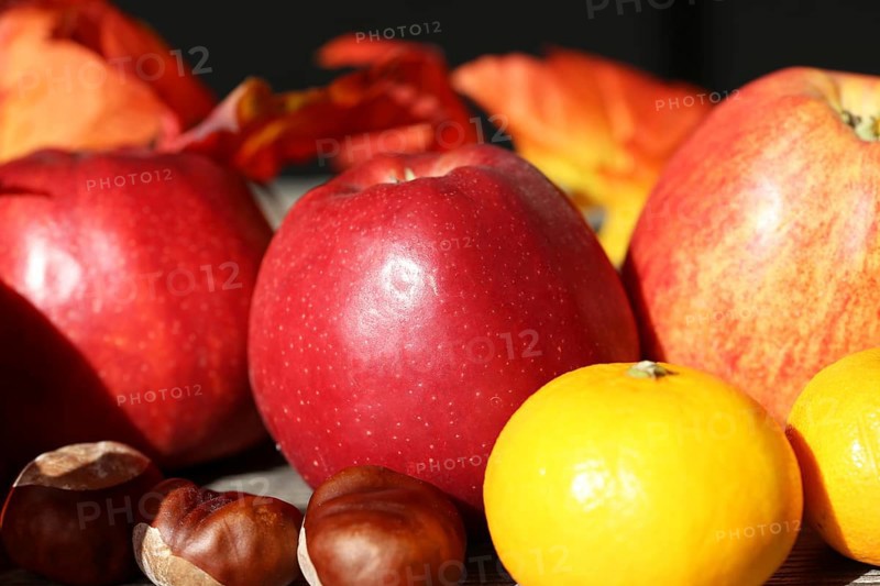 Apples and mandarins on a rustic wooden table as an autumnal motif