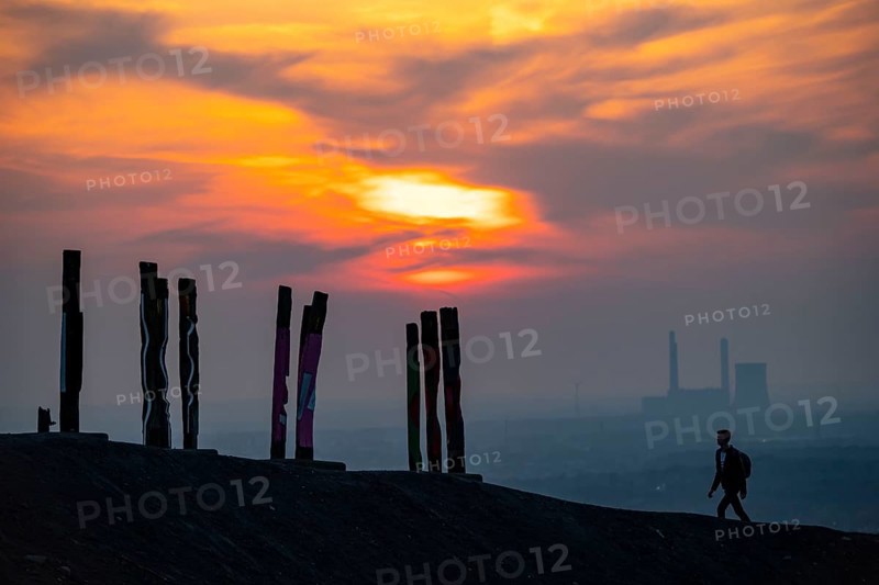 The Haniel spoil tip, 185 metre high spoil tip, at the Prosper Haniel mine, which was closed in 2019, artwork Totems by the sculptor Augustin Ibarrola, sunset, Bottrop, Germany, Europe