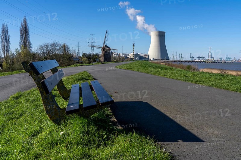 The Doel nuclear power plant on the Scheldt, one of two nuclear power plants in Belgium, consists of three operating units, each with a pressurised water reactor, as well as a decommissioned unit, historic Scheldemolen, windmill on the Scheldt dike, Antwerp, Belgium, Europe