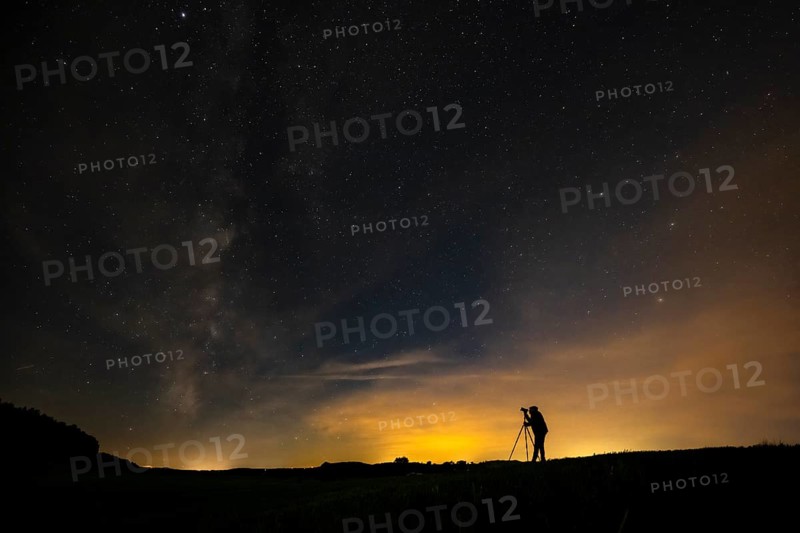 Photographer with tripod in a meadow with starry sky, Mindelheim, Unterallgäu, Bavaria, Germany, Europe
