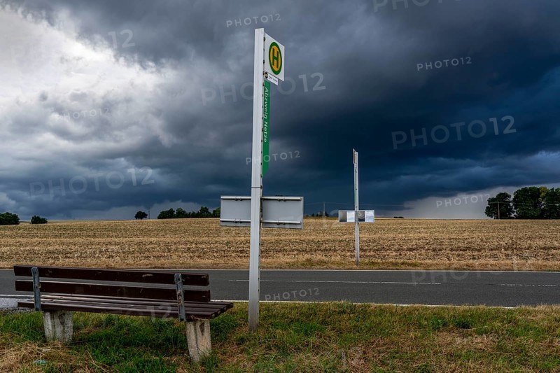 Single stop of bus line 510 between Korbach and Bad Wildungen, country road near Waldeck in North Hesse, bus stop Abzweig Netze, bus traffic between 6 a.m. and 5 p.m., NVV, Nordhessische VerkehrsVerbund, thunderstorm front approaching, Germany, Europe