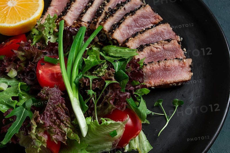 Vegetable salad, with fried tuna, in sesame seeds, healthy food, top view