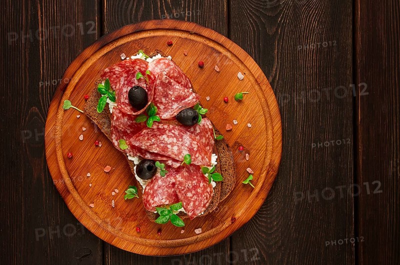 Sandwich, grain bread, with cream cheese and salami, black olives, micro-greens, top view, close-up, no people, Breakfast