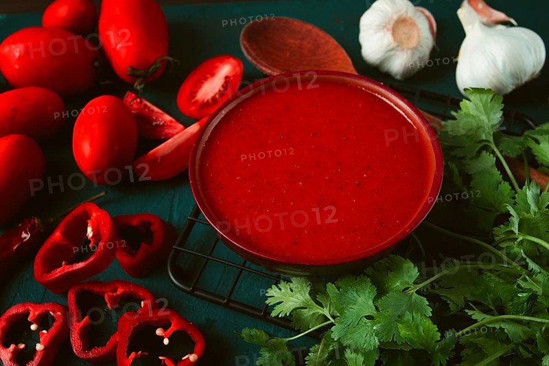 Tomato sauce, tomatoes and sweet pepper, Georgian Satsebeli sauce, with ingredients on a dark background, top view, close-up, no people