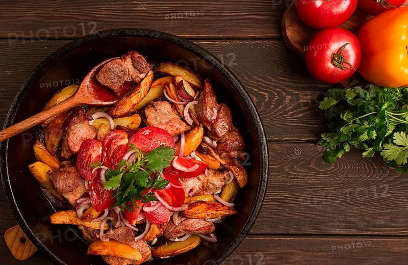 Ojakhuri, Traditional Georgian dish, fried potatoes with meat, in a clay frying pan, top view, no people, homemade