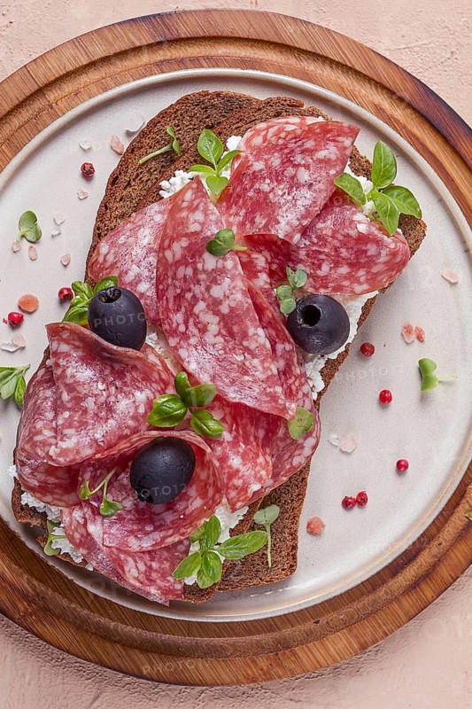 Sandwich, grain bread, with cream cheese and salami, black olives, micro-greens, top view, close-up, no people, Breakfast