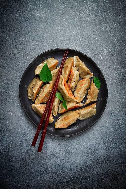 Japanese fried dumplings, gyoza, sesame seeds, top view, no people
