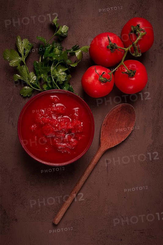 Tomatoes in their own juice, sliced, tomato sauce, tomatoes, in a cup, top view, close-up, no people
