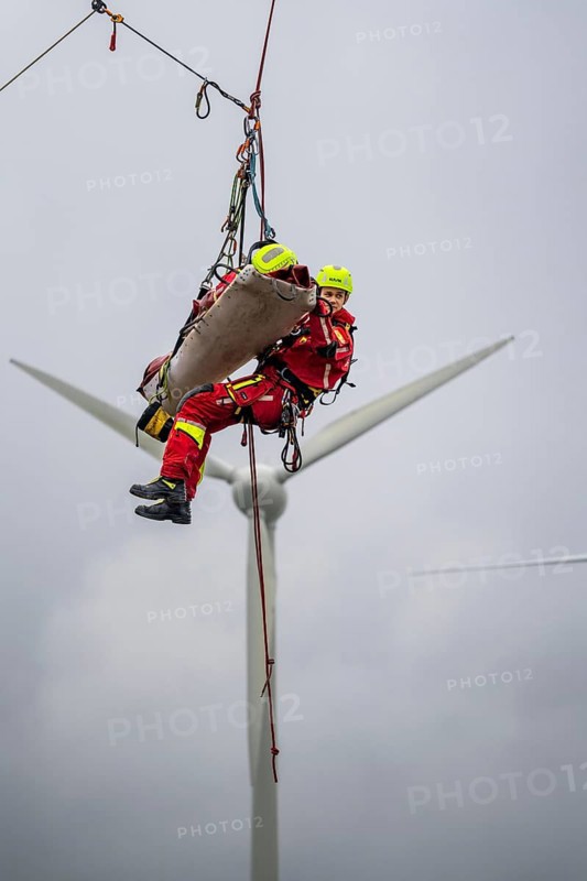 Height rescuers from the Oberhausen professional fire brigade practise abseiling from a wind turbine from a height of 150 metres, rescuing an injured person, technician, from the nacelle, Issum, North Rhine-Westphalia, Germany, Europe