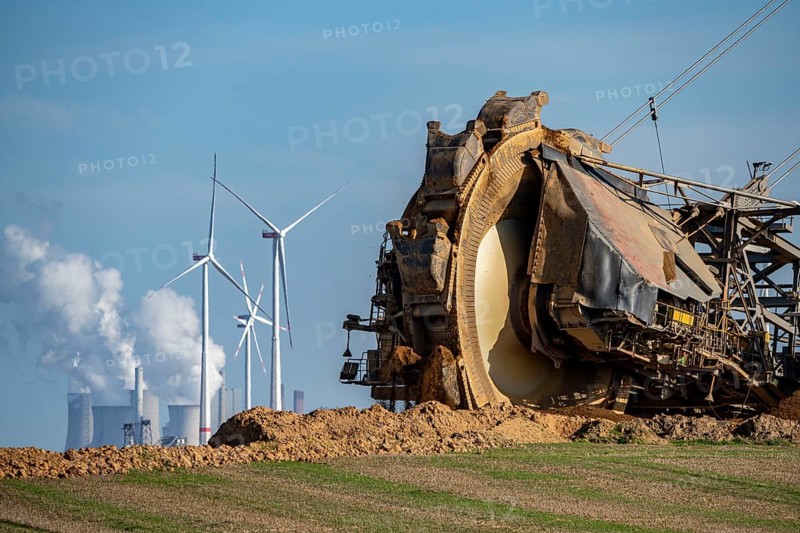 Opencast lignite mine Garzweiler II, bucket wheel excavator dredging, at the edge of the opencast mine near the village of Lützerath, belongs to Erkelenz in the district of Heinsberg, in the background wind farm, and the lignite-fired power plant Neurath, North Rhine-Westphalia, Germany, Europe