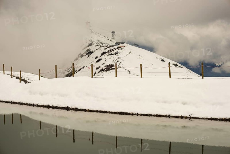 After snowfall in May: Riezler Alpsee, an artificial lake, snow pond, feeds the snow cannons that completely cover the slopes of the Fellhorn and Kanzelwand cable cars with snow, Allgäu Alps, Vorarlberg, Austria, Europe