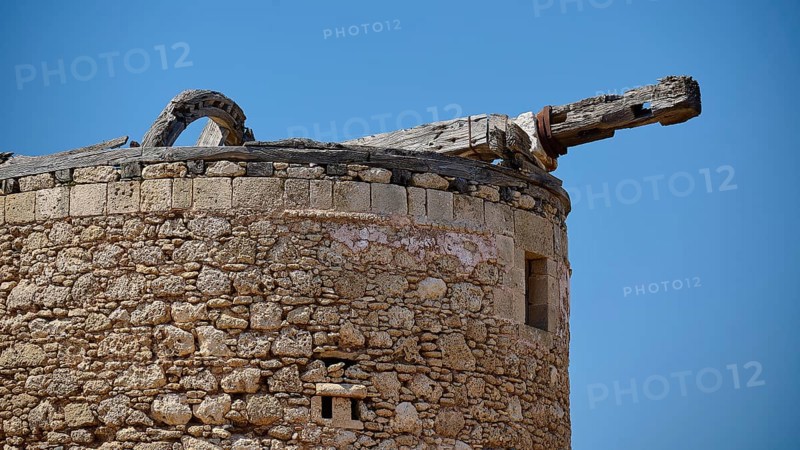A historic round tower with stone walls and old wooden beams under a clear sky, windmill, ruin, near Lindos, Lindos, Rhodes, Dodecanese, Greek Islands, Greece, Europe