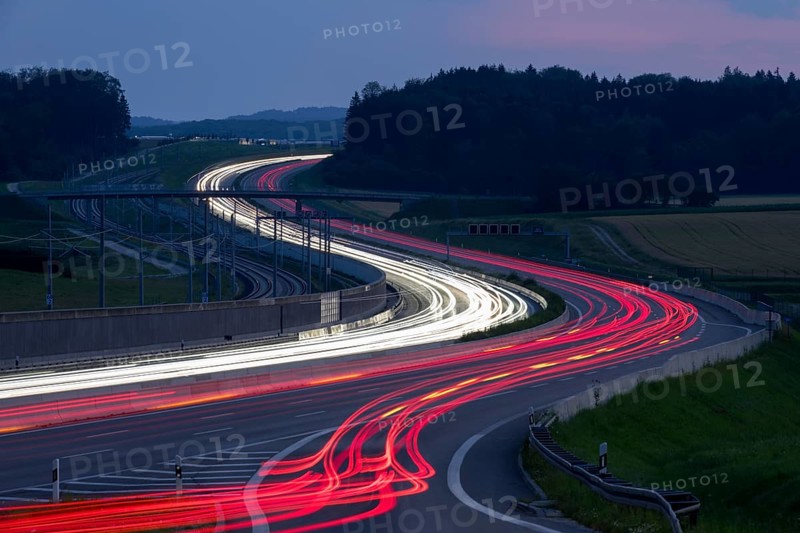 Tracers on the A8 motorway, winding road, evening, long exposure, Swabian Alb, Baden-Württemberg, Germany, Europe