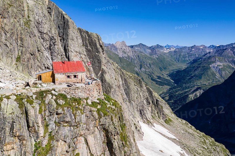 Aerial view of mountain hut Cabane de l'A Neuve, located on a steep rock formation, near La Fouly, Val de Ferret, Switzerland, Europe