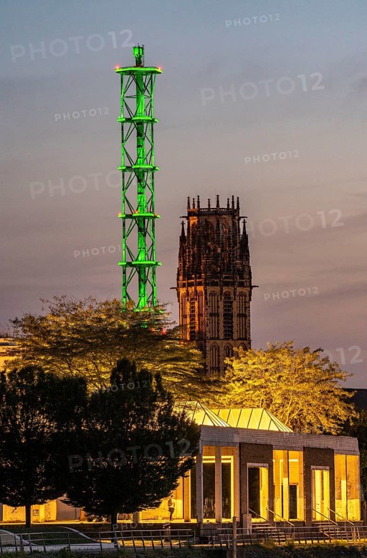 The Stadtwerketurm Duisburg, light installation, decommissioned chimney tower of a former thermal power station, listed building, tower of the Salvatorkirche, North Rhine-Westphalia, Germany, Europe