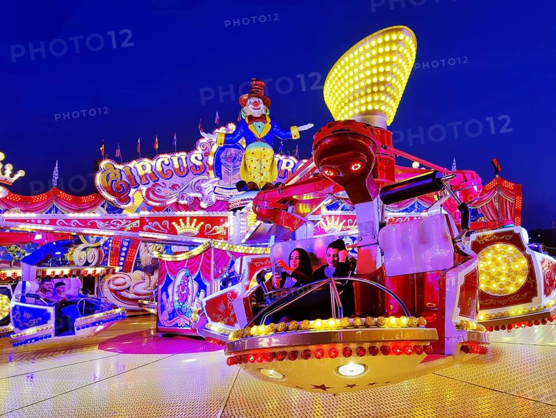 People in the illuminated carousel Circus Circus in the evening, Cranger Kirmes, Herne, Ruhr area, North Rhine-Westphalia, Germany, Europe