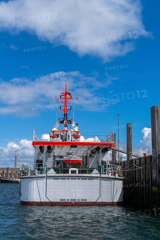 DGzRS rescue cruiser Hermann Marwede with dinghy in the harbour, stern view, Helgoland island, blue sky, North Sea, Pinneberg district, Schleswig-Holstein, Germany, Europe