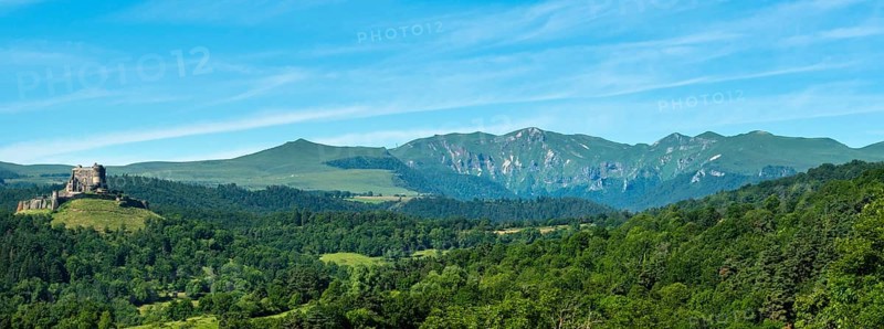 View of the medieval castle of Murol and the Sancy massif in the Auvergne Volcanoes Regional Natural Park, Puy de Dome, France, Europe