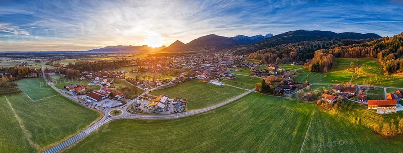 Panoramic view of a wide landscape with a village and mountains in the evening light, Bad Feilnbach