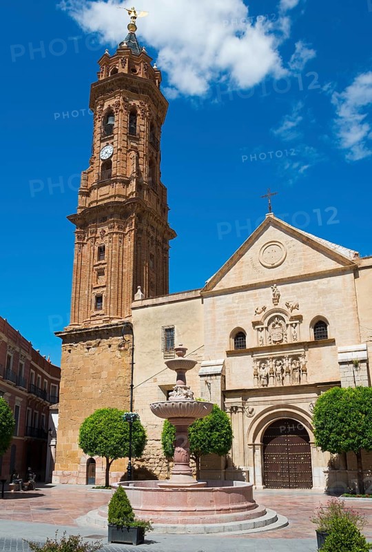 Church building with high tower and fountain on a sunny town square under a blue sky, Real Colegiata de San Sebastián, Royal Collegiate Church of San Sebastian, Antequera, Malaga, Andalusia, Spain, Europe