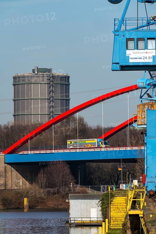 Gasometer of the Prosperität coking plant in Bottrop, cranes in Essen city harbour, motorway bridge of the A42 motorway, Emscher expressway, heavy goods traffic over the Rhine-Herne Canal, Essen North Rhine-Westphalia, Germany, Europe