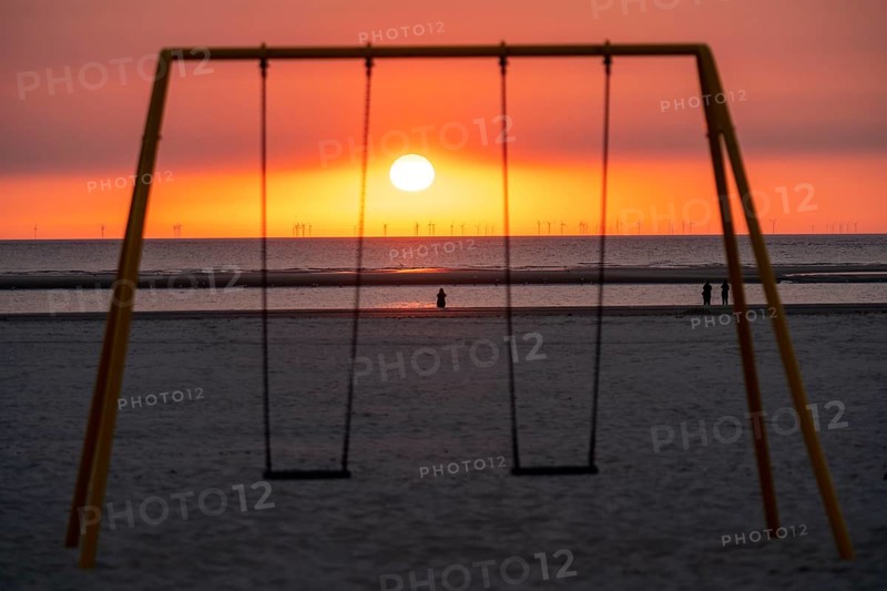 North Sea island Langeoog, early summer, beach, children's swing, offshore wind farm, sunset, Lower Saxony, Germany, Europe