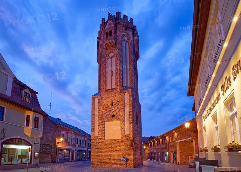 The brick Gothic Owl Tower, illuminated at night, in the old town centre of Tangermünde, Hanseatic town in the Altmark. Saxony-Anhalt, Germany, Europe