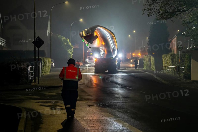 Transport of a 68 metre long, 22 tonne blade of a wind turbine, here in Breckerfeld, with a self-propelled Blade-Lifter vehicle, over a 40 km long route, over 2 nights, in the Bergisches Land, through towns, villages, over country roads, narrow through roads, to the construction site of the wind turbine near Hagen, North Rhine-Westphalia, Germany, Europe
