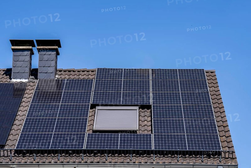 Solar system on the pitched roof of a residential building, photovoltaics for power generation, for own consumption and grid feed-in, North Rhine-Westphalia, Germany, Europe