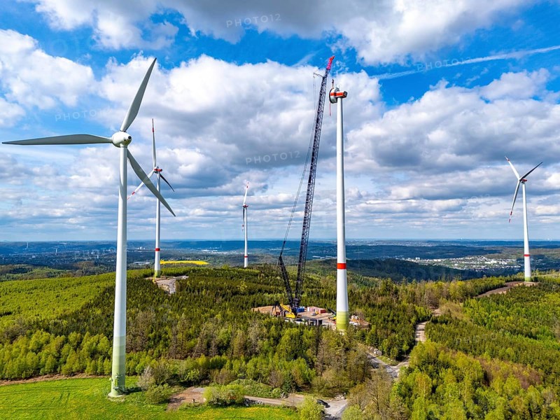 Erection of a wind turbine, wind energy plant, assembly of the ring generator, with a crawler lattice crane, wind farm near Hagen, North Rhine-Westphalia, Germany, Europe