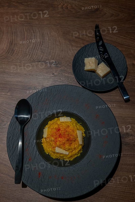 Elegant Plate with Risotto alla Milanese with Saffron and Parmesan Cheese in Lugano, Ticino, Switzerland, Europe