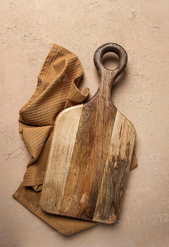 Cutting board, wooden, rectangular shape, with handle, with kitchen towel, top view, no people