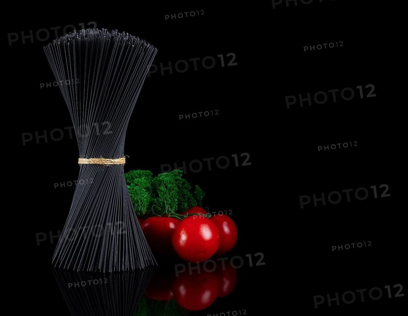 Bouquet, black spaghetti Nori, with ingredients, tomatoes and basil, on a black background, horizontal, no people