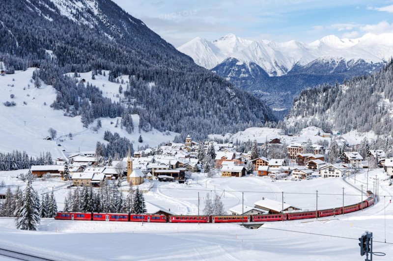 Rhaetian Railway train on the Albula railway Passenger train in the Alps in Bergün, Switzerland, Europe
