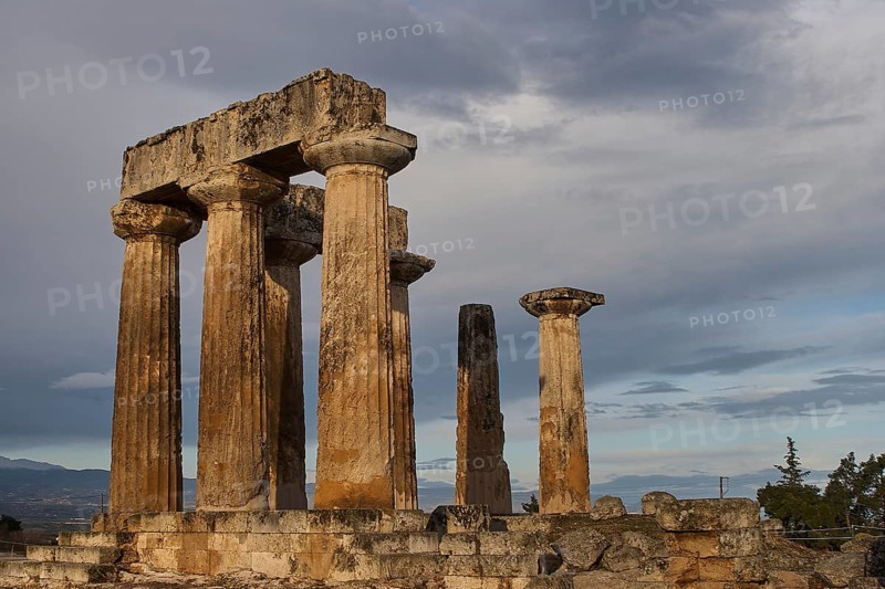 Archaic Temple of Apollo, Doric Columns, Ancient Greek columns stand tall under a dramatic evening sky, Archaeological site, Archea Korinthos, Corinth, Peloponnese, Greece, Europe