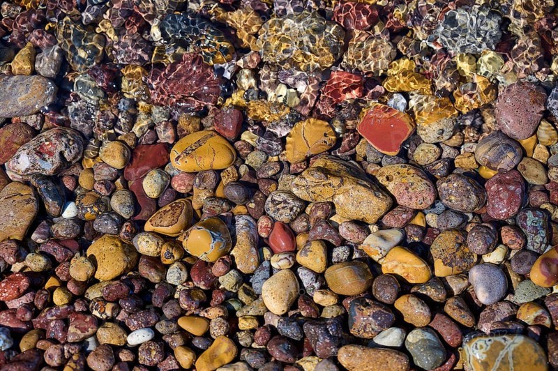 Colourful pebbles under clear water, forming a varied texture and natural patterns, Lambi beach, pebble beach, Patmos, Dodecanese, Greek Islands, Greece, Europe