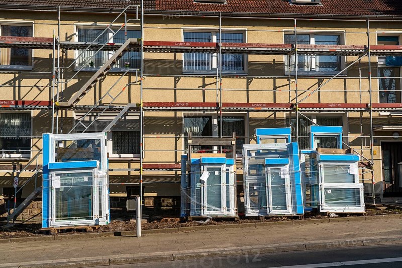 Energy-efficient refurbishment of residential buildings, older apartment block is scaffolded, gets thermal insulation and new windows, Germany, Europe