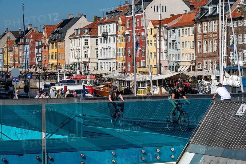 Cyclists on the Inderhavnsbroen cycle and footpath bridge, over the harbour, at Nyhavn, Copenhagen is considered the cycling capital of the world, 45 % of the population travel by bike, Denmark, Europe