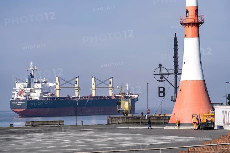 Weser estuary near Bremerhaven, Willy-Brandt-Platz, monument to the emigrants, Seebäderkaje, cargo ship, lighthouse, wind semaphore, Bremen, Germany, Europe