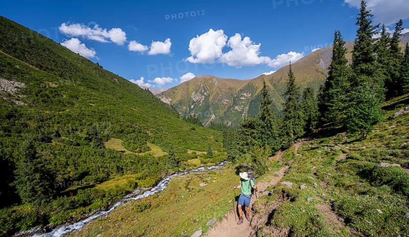 Mountaineers on a hiking trail by a mountain stream, Keldike Valley on the way to the Ala Kul Pass, Tien Shan Mountains, Kyrgyzstan, Asia