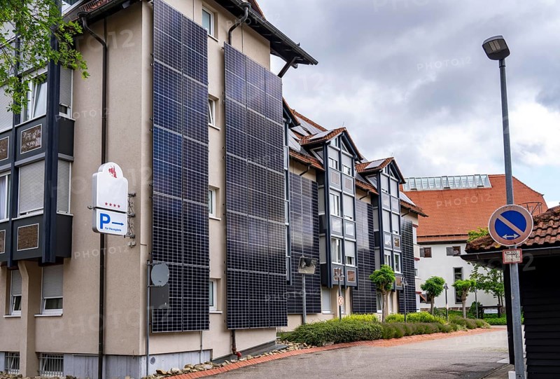 Solar façade, photovoltaic elements on a building façade, hotel in Herrenberg, large PV modules generate electricity on the outer walls of the building, Herrenberg, Baden-Württemberg, Germany, Europe