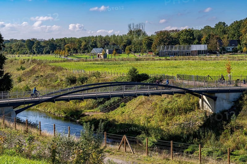 Bridge over the renaturalised Emscher in Emscherland, a new nature and water adventure park at the water crossing of the Emscher with the Rhine-Herne Canal, with lots of nature and recreational areas and information centres on the Emscher conversion and regional nature, North Rhine-Westphalia, Germany, Europe