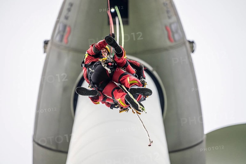 Height rescuers from the Gelsenkirchen fire brigade practise abseiling from a wind turbine from a height of 110 metres after rescuing an accident victim from the nacelle, Gladbeck, North Rhine-Westphalia, Germany, Europe