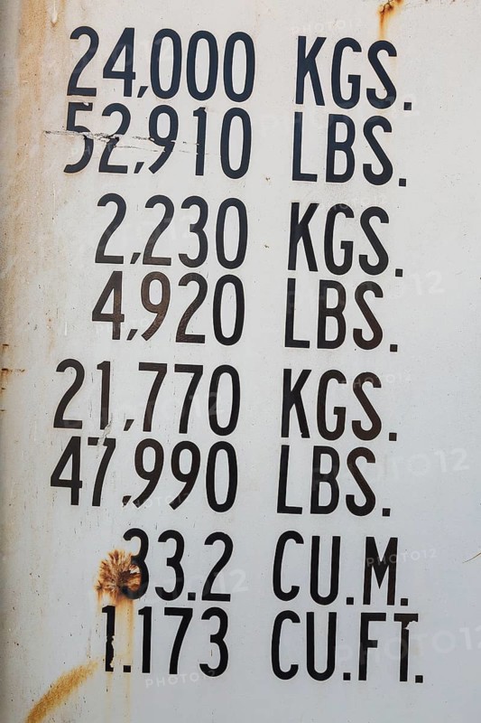 Close-up of maximum cargo cubic weight holding capacity indicated in kilograms and pounds on outside of shipping container, Quebec, Canada, North America