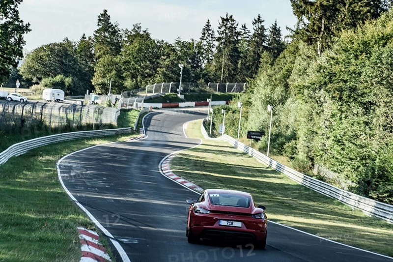 View from the perspective of racing driver on sports car Porsche Cayman driving on Nürburgring race track Nordschleife Green Hell Green Hell international official race track for motorsport in front of Pflanzgarten section with jump hill on former historic country road in low mountain range Eifel, Nürburg, Rhineland-Palatinate, Germany, Europe