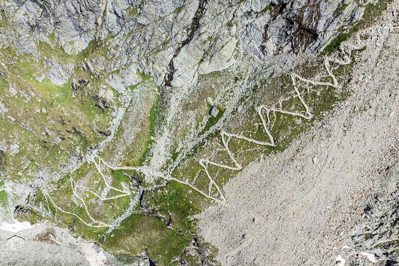 Serpentines of hiking trail up to mountain hut Cabane de Moiry, aerial view, Valais, Switzerland, Europe
