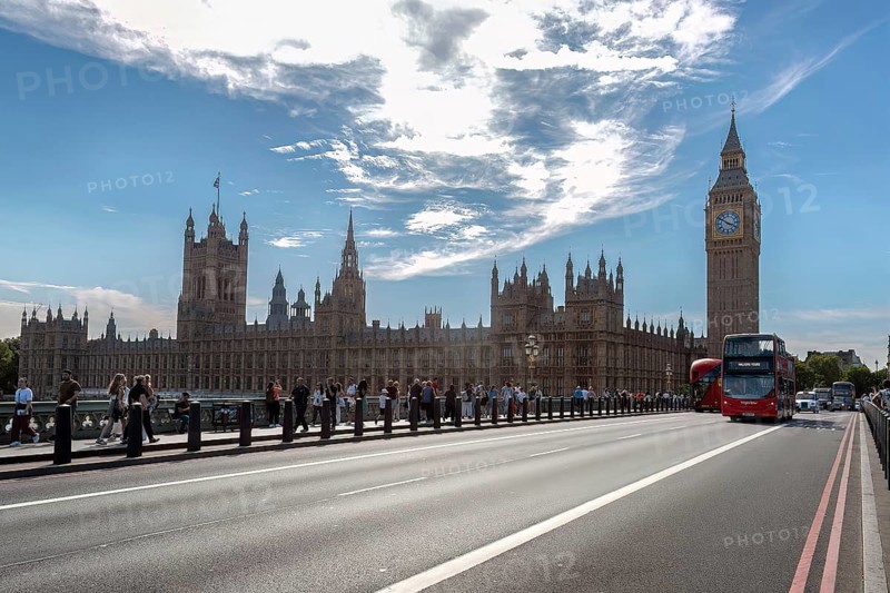 Big Ben and Palace of Westminster behind a bridge with buses and tourists, London, United Kingdom, Europe